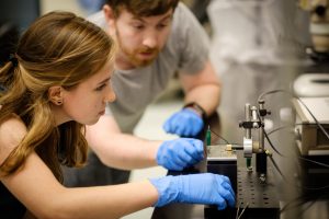 Wake Forest students work in the research lab of physics professor Oana Jurchescu in Olin Hall on Wednesday, October 11, 2017. Katrina Barth ('18) and graduate student Zach Lamport work with a tiny experimental chip.